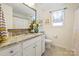 Well-lit bathroom featuring granite countertop, white cabinets, and a framed mirror at 4607 Bonroi Ave, Charlotte, NC 28213