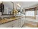 Elegant bathroom featuring granite countertops, dual sinks, soaking tub and decorative accents at 4607 Bonroi Ave, Charlotte, NC 28213