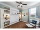 Cozy bedroom offers a murphy bed, built in bookcases, and sitting area at 4607 Bonroi Ave, Charlotte, NC 28213