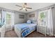 Inviting bedroom with gray walls, a ceiling fan, and coordinated blue bedding for a serene atmosphere at 4607 Bonroi Ave, Charlotte, NC 28213