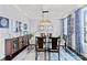 Bright dining room features elegant chandelier, modern decor, and glass top table at 4607 Bonroi Ave, Charlotte, NC 28213