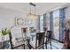 Bright dining room boasts coffered ceilings, glass table and striking blue patterned drapes at 4607 Bonroi Ave, Charlotte, NC 28213
