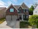 Beautiful two-story brick home featuring a two-car garage, manicured lawn, and a welcoming front porch at 4607 Bonroi Ave, Charlotte, NC 28213