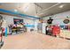 Spacious garage with painted floors, extra refrigerator, storage, and work area at 4607 Bonroi Ave, Charlotte, NC 28213