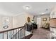 Upstairs hallway featuring railing and desk area with laundry room access at 4607 Bonroi Ave, Charlotte, NC 28213