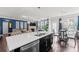 Modern kitchen with a large island, stainless steel appliances, breakfast bar, and an adjacent dining area at 4607 Bonroi Ave, Charlotte, NC 28213