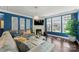 Comfortable living room with a modern stone fireplace, blue accent wall, and a large gray sectional sofa at 4607 Bonroi Ave, Charlotte, NC 28213