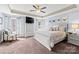 Comfortable main bedroom featuring a tray ceiling, neutral color palette, and ceiling fan at 4607 Bonroi Ave, Charlotte, NC 28213