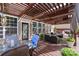 Inviting covered patio with comfortable seating, ceiling fan, and well-maintained wood decking at 4607 Bonroi Ave, Charlotte, NC 28213
