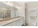Bright bathroom featuring double sink vanity, granite countertop, and tiled shower at 4991 Looking Glass Trl, Denver, NC 28037