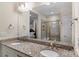 Bathroom with double sink vanity and a view of the bedroom and tiled shower at 4991 Looking Glass Trl, Denver, NC 28037