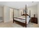 Four poster bed in primary bedroom with adjacent ensuite and barn door at 4991 Looking Glass Trl, Denver, NC 28037