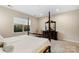Well-lit bedroom with a four-poster bed, a window, and traditional decor at 4991 Looking Glass Trl, Denver, NC 28037