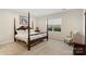 Bedroom features a four-poster bed, neutral color palette, and natural light at 4991 Looking Glass Trl, Denver, NC 28037