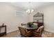 Cozy dining area with a round table, cushioned chairs, and a stylish light fixture at 4991 Looking Glass Trl, Denver, NC 28037