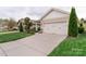 Charming home featuring a two-car garage, well-manicured lawn, and beautiful landscaping at 4991 Looking Glass Trl, Denver, NC 28037