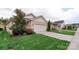 Charming home featuring a two-car garage, well-manicured lawn, and beautiful landscaping at 4991 Looking Glass Trl, Denver, NC 28037