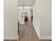 Light and bright hallway leading to dining and living spaces with beautiful flooring at 4991 Looking Glass Trl, Denver, NC 28037