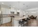 A well-equipped kitchen features an island with barstool seating and stainless steel appliances at 4991 Looking Glass Trl, Denver, NC 28037