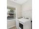 Bright laundry room featuring a side-by-side washer and dryer with a window at 4991 Looking Glass Trl, Denver, NC 28037