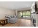 Living area featuring a large couch, hardwood flooring, a fireplace and sliding glass doors at 4991 Looking Glass Trl, Denver, NC 28037