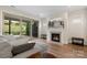 Bright living room with a fireplace, large sliding glass doors, and an outdoor view at 4991 Looking Glass Trl, Denver, NC 28037
