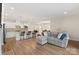 Bright, open-concept living room showcasing hardwood floors and seamless flow with the kitchen at 4991 Looking Glass Trl, Denver, NC 28037