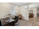 Bright home office with a comfortable chair, a window, and an open view to the dining area at 4991 Looking Glass Trl, Denver, NC 28037