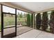Enclosed porch with a view of a spacious backyard features a patio and surrounding trees at 4991 Looking Glass Trl, Denver, NC 28037