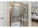 Tiled shower with glass enclosure and built-in bench, visible from the ensuite at 4991 Looking Glass Trl, Denver, NC 28037