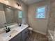 Bathroom with double vanity, quartz countertop and black hardware at 5006 Mclaughlin Dr # 103, Waxhaw, NC 28173