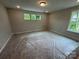 Bright bedroom featuring three windows that offer natural light and green views at 5006 Mclaughlin Dr # 103, Waxhaw, NC 28173