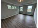 Bedroom with hardwood floors, three large windows, and neutral walls at 5006 Mclaughlin Dr # 103, Waxhaw, NC 28173