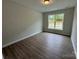 Bedroom with wood-look floors, one window, and neutral-colored walls at 5006 Mclaughlin Dr # 103, Waxhaw, NC 28173