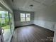 Dining room with wood floors, modern lighting, and sliding glass doors to the outdoor patio at 5006 Mclaughlin Dr # 103, Waxhaw, NC 28173