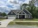 Charming new construction home featuring a well-manicured lawn and a spacious white two-car garage at 5006 Mclaughlin Dr # 103, Waxhaw, NC 28173