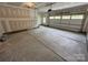 Spacious unfinished garage with concrete flooring, window and a closed white garage door at 5006 Mclaughlin Dr # 103, Waxhaw, NC 28173