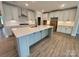 Large kitchen island with seating, white cabinets, and modern appliances at 5006 Mclaughlin Dr # 103, Waxhaw, NC 28173
