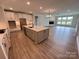 Open-concept kitchen with large island, stainless appliances, and eat in area at 5006 Mclaughlin Dr # 103, Waxhaw, NC 28173