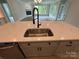 Close-up of large kitchen island featuring a stainless-steel sink and modern faucet at 5006 Mclaughlin Dr # 103, Waxhaw, NC 28173