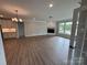 Spacious living room featuring wood floors, a fireplace, and large windows offering natural light at 5006 Mclaughlin Dr # 103, Waxhaw, NC 28173