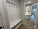 View of the mudroom featuring coat hooks, bench and storage leading to additional cabinetry at 5006 Mclaughlin Dr # 103, Waxhaw, NC 28173