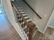 Staircase with wood handrail and wood-look flooring at 5006 Mclaughlin Dr # 103, Waxhaw, NC 28173