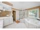 Well-lit bathroom with a glass enclosed shower, tub, and vanity at 511 Pembroke Ln, Waxhaw, NC 28173