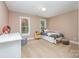 Bright bedroom with two windows, a bed, a desk and a dresser at 511 Pembroke Ln, Waxhaw, NC 28173