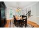 Elegant dining room featuring hardwood floors, wainscoting, and chandelier lighting for formal meals at 511 Pembroke Ln, Waxhaw, NC 28173
