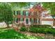 Charming two-story brick home with a well-manicured lawn and mature trees at 511 Pembroke Ln, Waxhaw, NC 28173