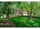 Charming two-story brick home with a well-manicured lawn and mature trees at 511 Pembroke Ln, Waxhaw, NC 28173