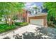 Spacious two-car garage attached to a brick home with dormer windows and lush landscaping at 511 Pembroke Ln, Waxhaw, NC 28173