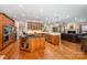Bright kitchen with wooden cabinets, granite countertops, stainless steel appliances, and open to living room at 511 Pembroke Ln, Waxhaw, NC 28173